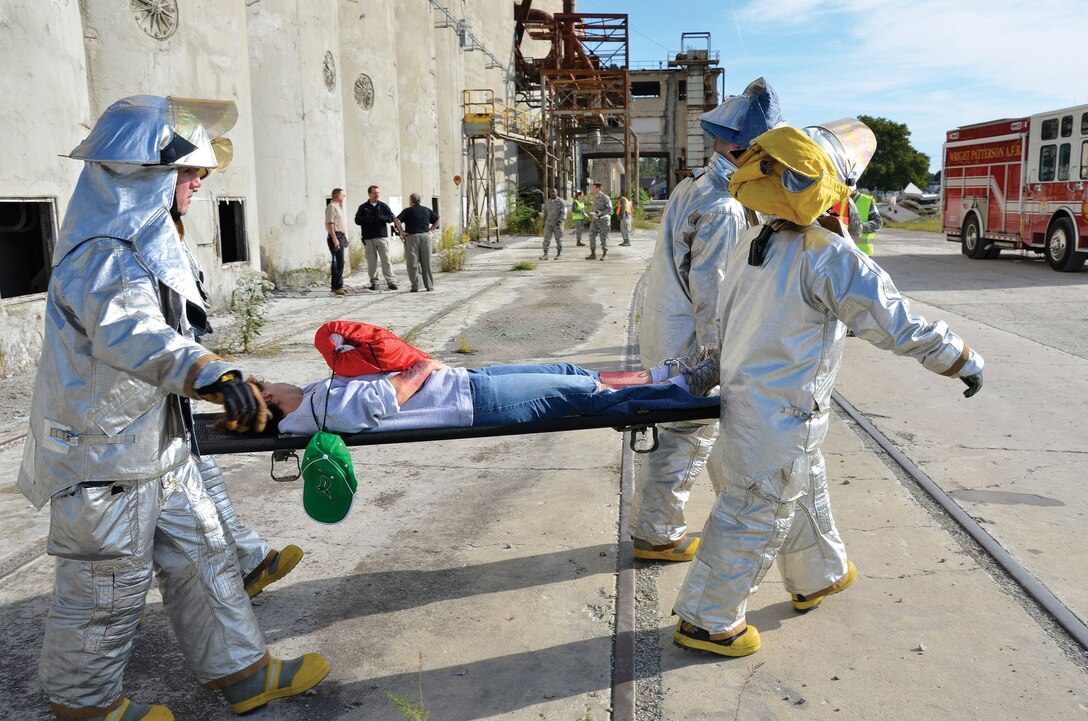 FAIRBORN, Ohio - Firefighters assigned to the 445th Civil Engineer Squadron carry a patient after a simulated building collapse scenario during the wing’s disaster response exercise, Sept. 14, 2014 at Calamityville, National Center for Medical Readiness, Fairborn, Ohio. (U.S. Air Force photo/Lt. Col. Denise Kerr)