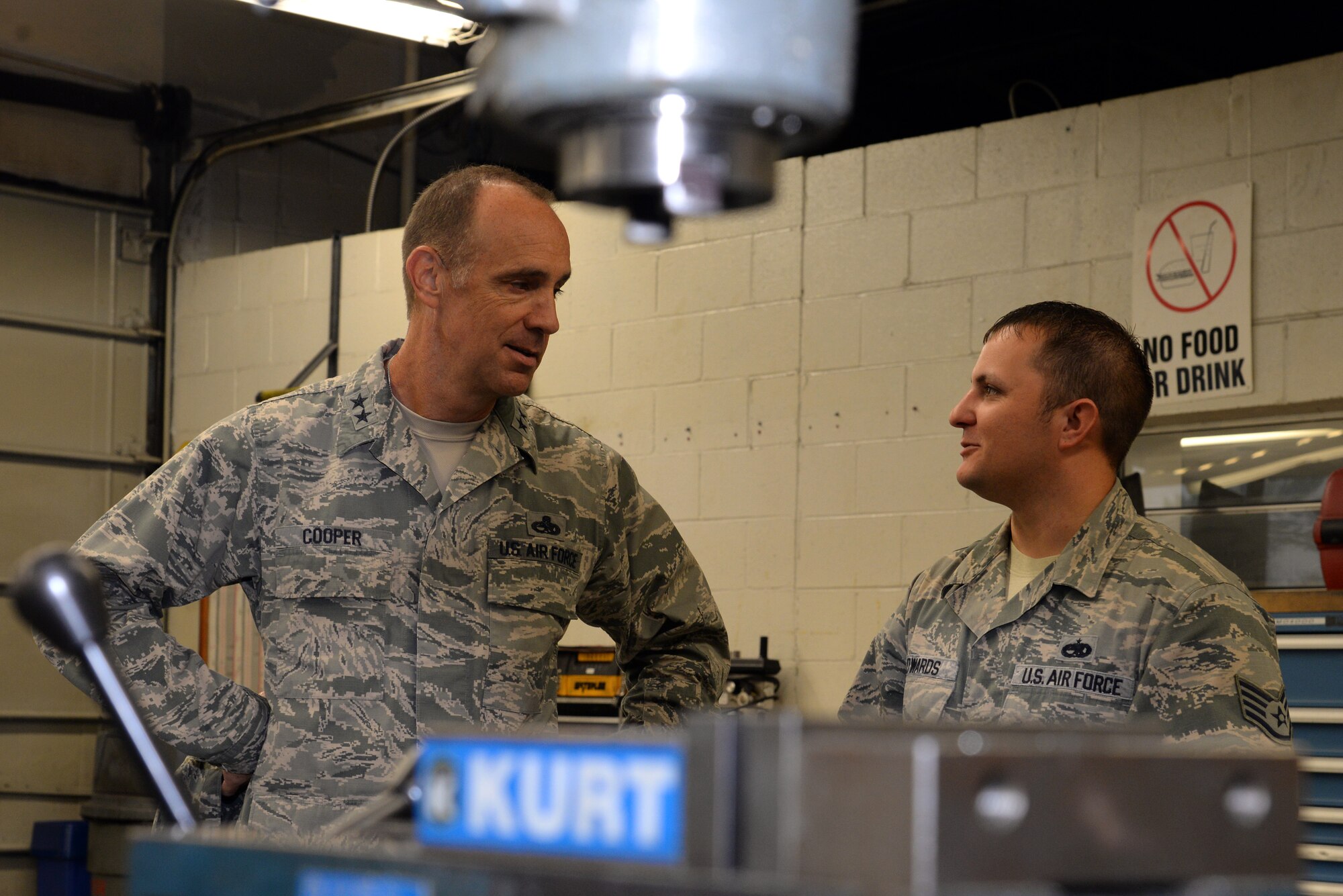 U.S. Air Force Maj. Gen. John Cooper, Air Combat Command director of logistics, discusses the need for new equipment and software with Staff Sgt. Steven Edwards, 20th Equipment Maintenance Squadron air metals technician, in the metals technology flight at Shaw Air Force Base, S.C., Sept. 25, 2014. The new equipment is projected to increase productivity by 40 percent. (U.S. Air Force photo by Airman 1st Class Jonathan Bass/Released) 
