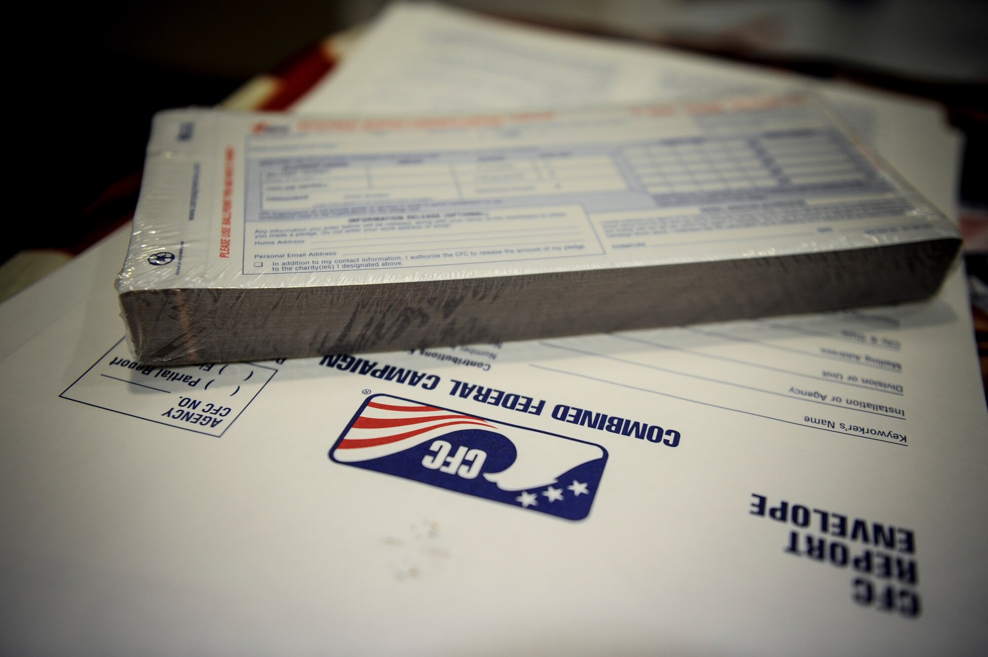 Combined Federal Campaign pledge cards sit on a table at the Moody Field Club during the official CFC Kick-Off ceremony at Moody Air Force Base, Ga., Sept. 29, 2014.  Pledges made by federal civilian and military donors during the campaign season support eligible non-profit organizations that provide benefits throughout the world. (U.S. Air Force photo by Andrea Jenkins/Released)