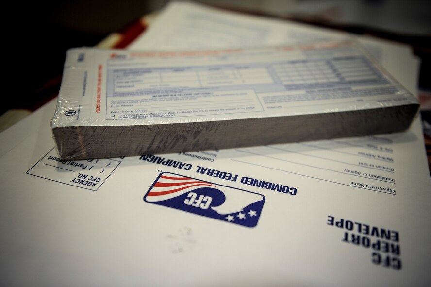 Combined Federal Campaign pledge cards sit on a table at the Moody Field Club during the official CFC Kick-Off ceremony at Moody Air Force Base, Ga., Sept. 29, 2014.  Pledges made by federal civilian and military donors during the campaign season support eligible non-profit organizations that provide benefits throughout the world. (U.S. Air Force photo by Andrea Jenkins/Released)