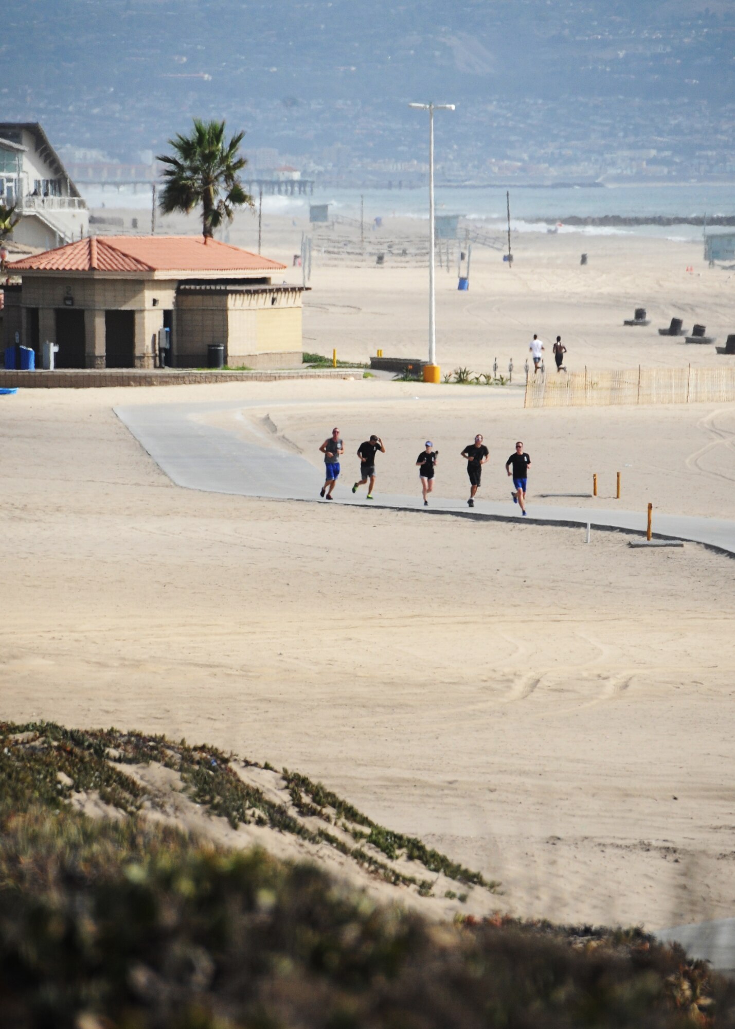 The Space and Missile Systems Center at Los Angeles Air Force Base, Calif., held its annual POW/MIA 24 hour Torch Relay, starting with a ceremony at the San Pedro Coast Guard Station, Sept. 18, 2014, where Coast Guard members ran the first leg, followed by LAAFB, then the Army and Navy from the MEPS Center in El Segundo through the South Bay Beach cities, to bring awareness about America’s POW/MIAs. The torch was carried around LAAFB’s track through the night culminating with a wreath laying ceremony at 9 a.m. on Friday, Sept. 19. (Photos by Joe Juarez, Sarah Corrice and Van Ha)