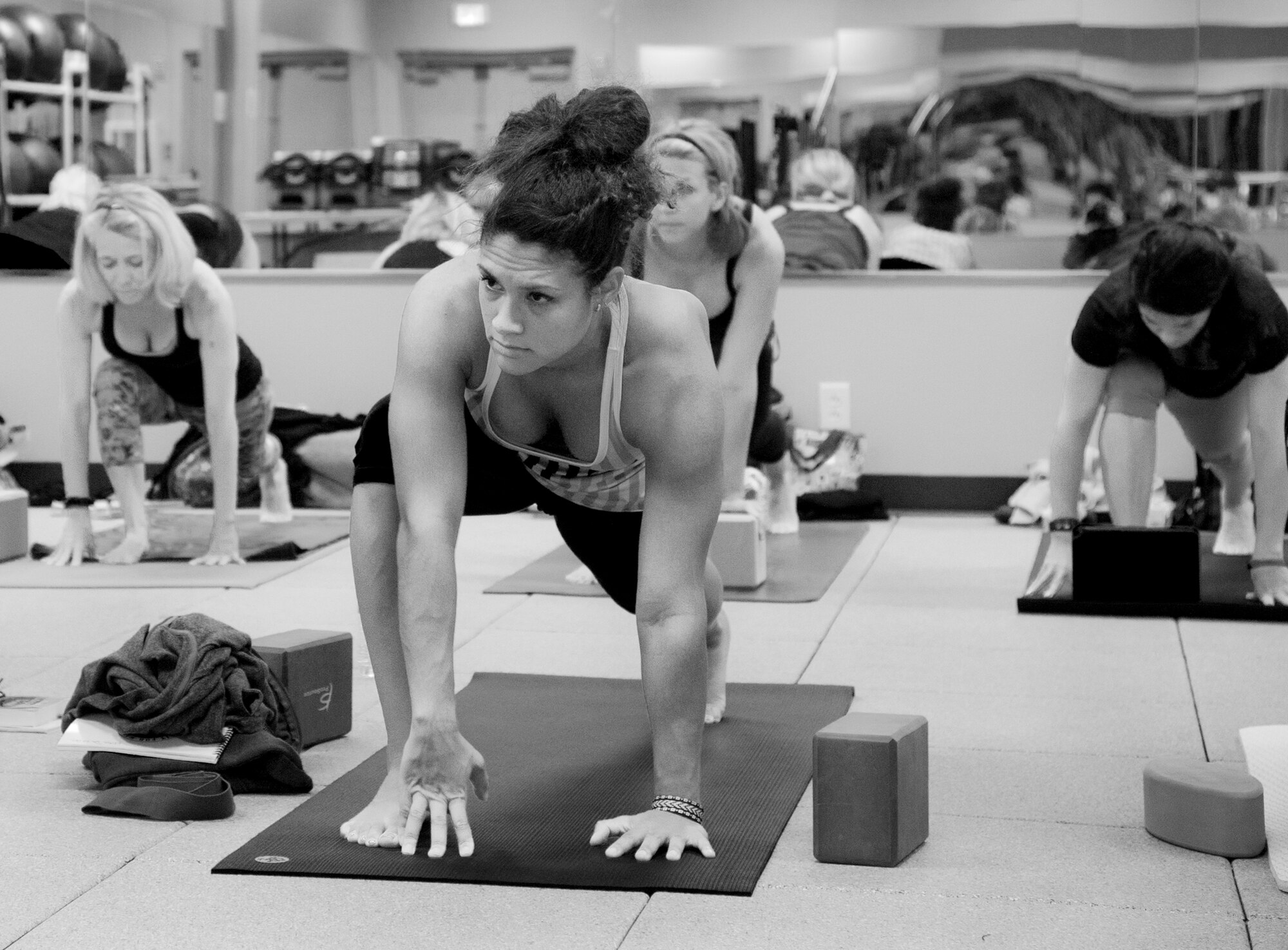 Erika DeLaCruz, a yoga class participant holds a low lunge pose on Sept. 27 at Eglin’s women’s field house.  The 96th Force Support Squadron hosted the 20 hour yoga workshop designed to assist participants in gaining a deeper understanding of how trauma is stored in the body.  This yoga program is different than traditional yoga practice in that it targets the healing of the central nervous system.  This program’s classes focus on slower organic yoga postures and movements while creating a safe space for the trauma survivor to heal.  (U.S. Air Force photo/Ilka Cole)