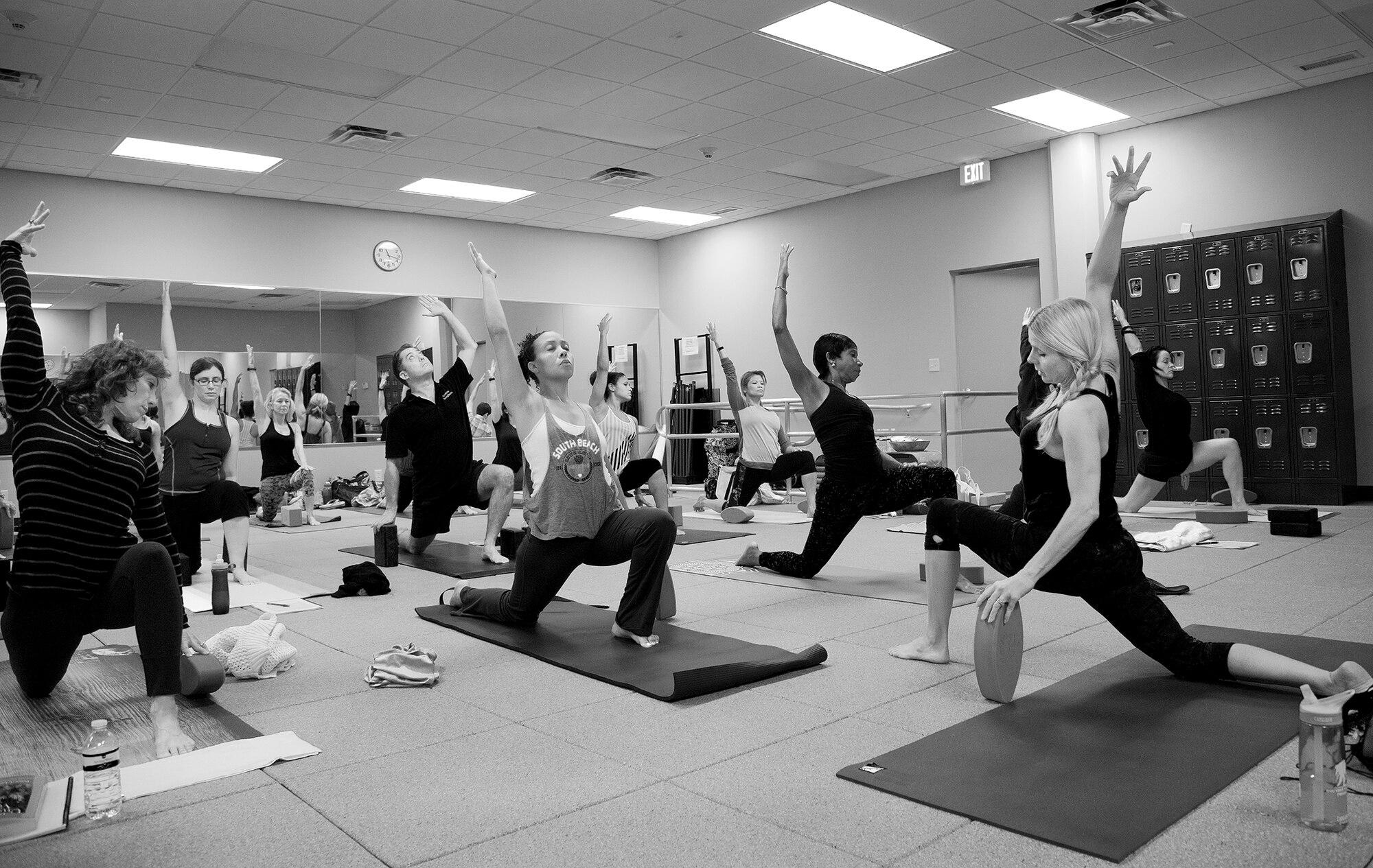 Yoga class participants move into a kneeling lunge pose led by YogaFit Master Instructor, Shaye Molendyke Sept. 27 at Eglin’s women’s field house.  The 96th Force Support Squadron hosted the 20 hour yoga workshop designed to assist participants in gaining a deeper understanding of how trauma is stored in the body.  This yoga program is different than traditional yoga practice in that it targets the healing of the central nervous system.  This program’s classes focus on slower organic yoga postures and movements while creating a safe space for the trauma survivor to heal.  (U.S. Air Force photo/Ilka Cole)