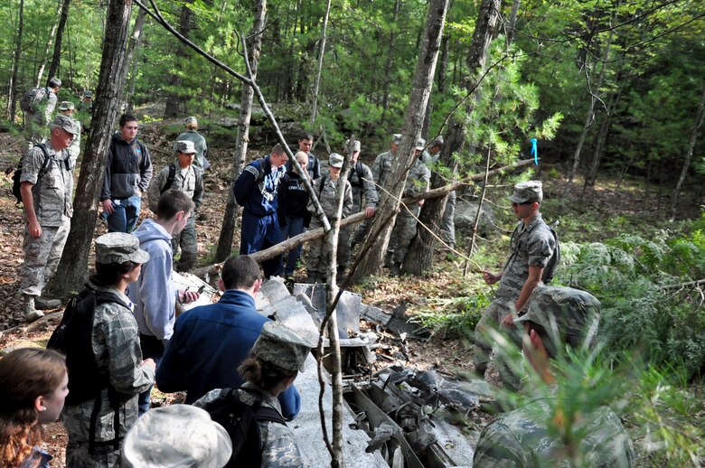 Members of the 23rd Space Operations Squadron brief University of New Hampshire Air Force ROTC cadets on a crash site as part of a land navigation and leadership exercise Sept. 20, 2014, at New Boston Air Force Station, N.H. This was the second time UNH cadets visited New Boston for a leadership exercise. (U.S. Air Force photo/Lt. Col. Sarah Jackson)