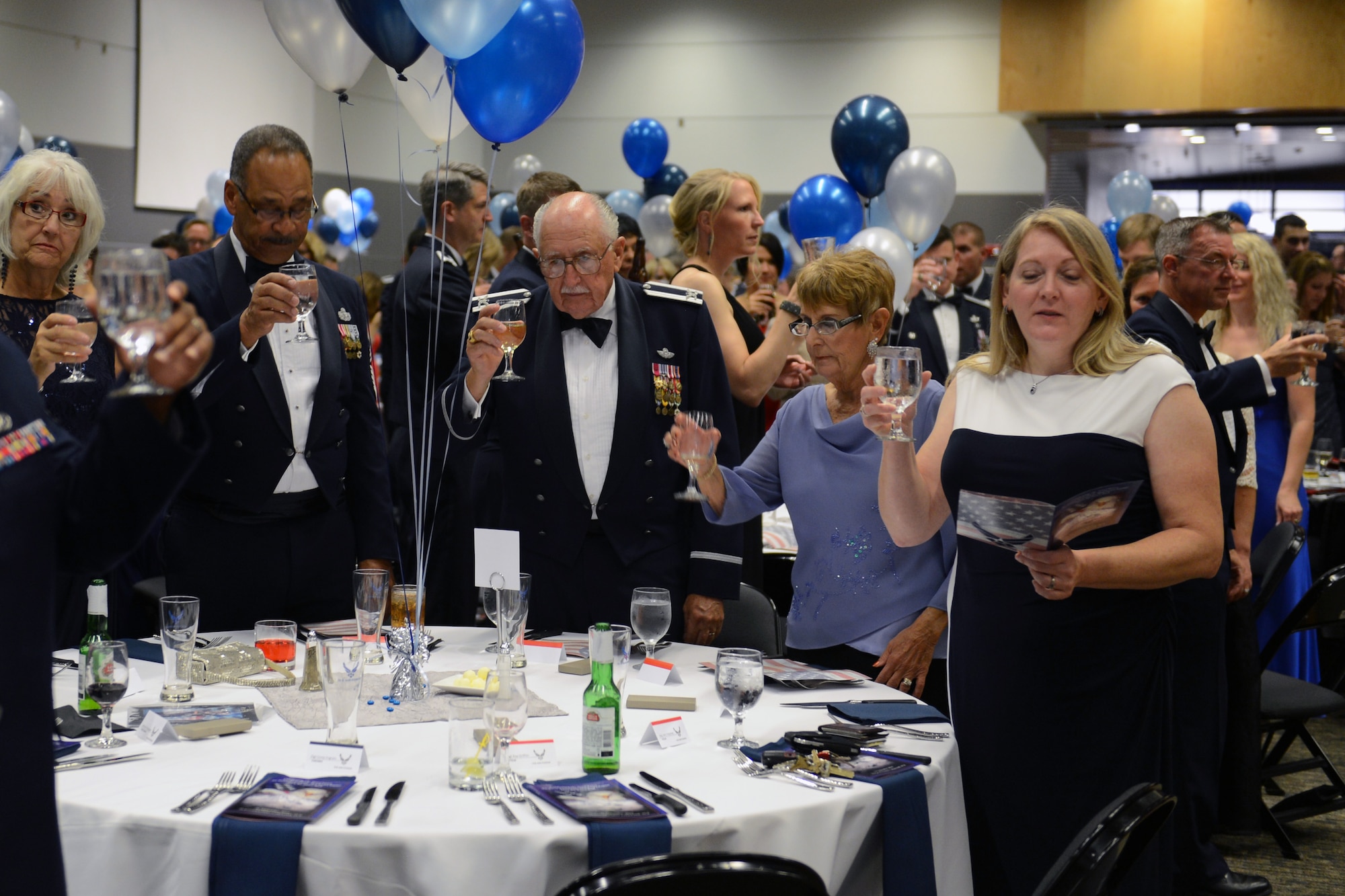 Attendees hold up their glasses for a toast Sept. 26, 2014 during the Air Force Ball at Clover Park Technical College, Lakewood, Wash. Throughout the evening, toasts were held for the total force team, the men and women who couldn’t attend because of their support to missions across the globe, and our countries leaders and fallen comrades.  (U.S. Air Force photo/Airman 1st Class Keoni Chavarria)