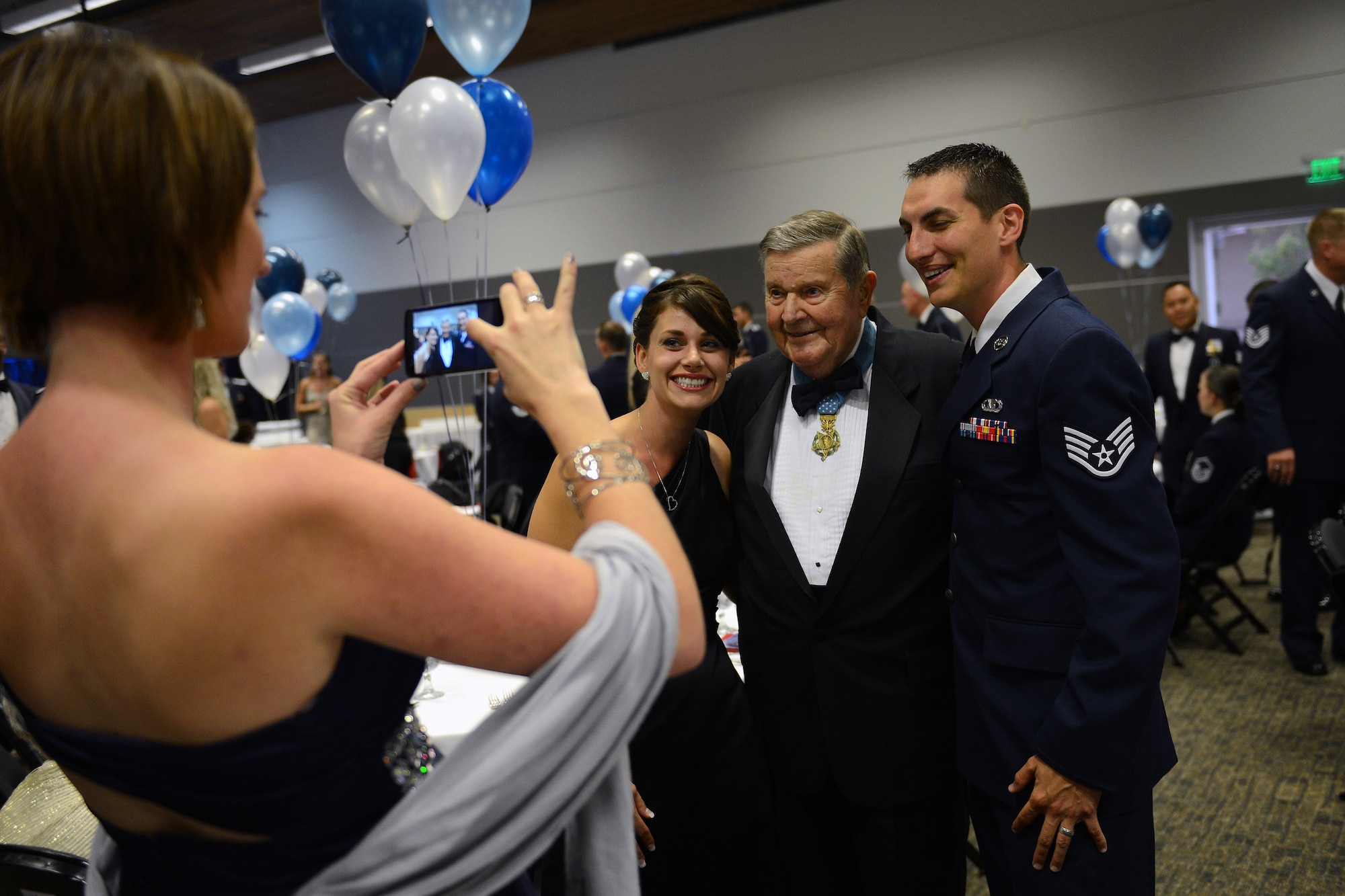 Attendees pose for a photo next to retired Col. Joe Jackson, Medal of Honor recipient, Sept. 26, 2014, during the Air Force Ball at Clover Park Technical College, Lakewood, Wash. Service members from the Air Force and the Army attended the ball, bringing their family members to enjoy the night of food, drinks and dancing. (U.S. Air Force photo/Airman 1st Class Keoni Chavarria)