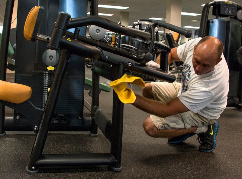 Tech. Sgt. John Branhof, 919th Special Operations Fore Support Squadron, cleans the exercise equipment during the GI party Sept. 6 at Duke Field, Fla.  Airmen, from the 919th Special Operations Mission Support Group, came together to scrub down and clean up the Duke Field gym and fitness areas during the September unit training assembly.  (U.S. Air Force photo/Tech. Sgt. Jasmin Taylor)