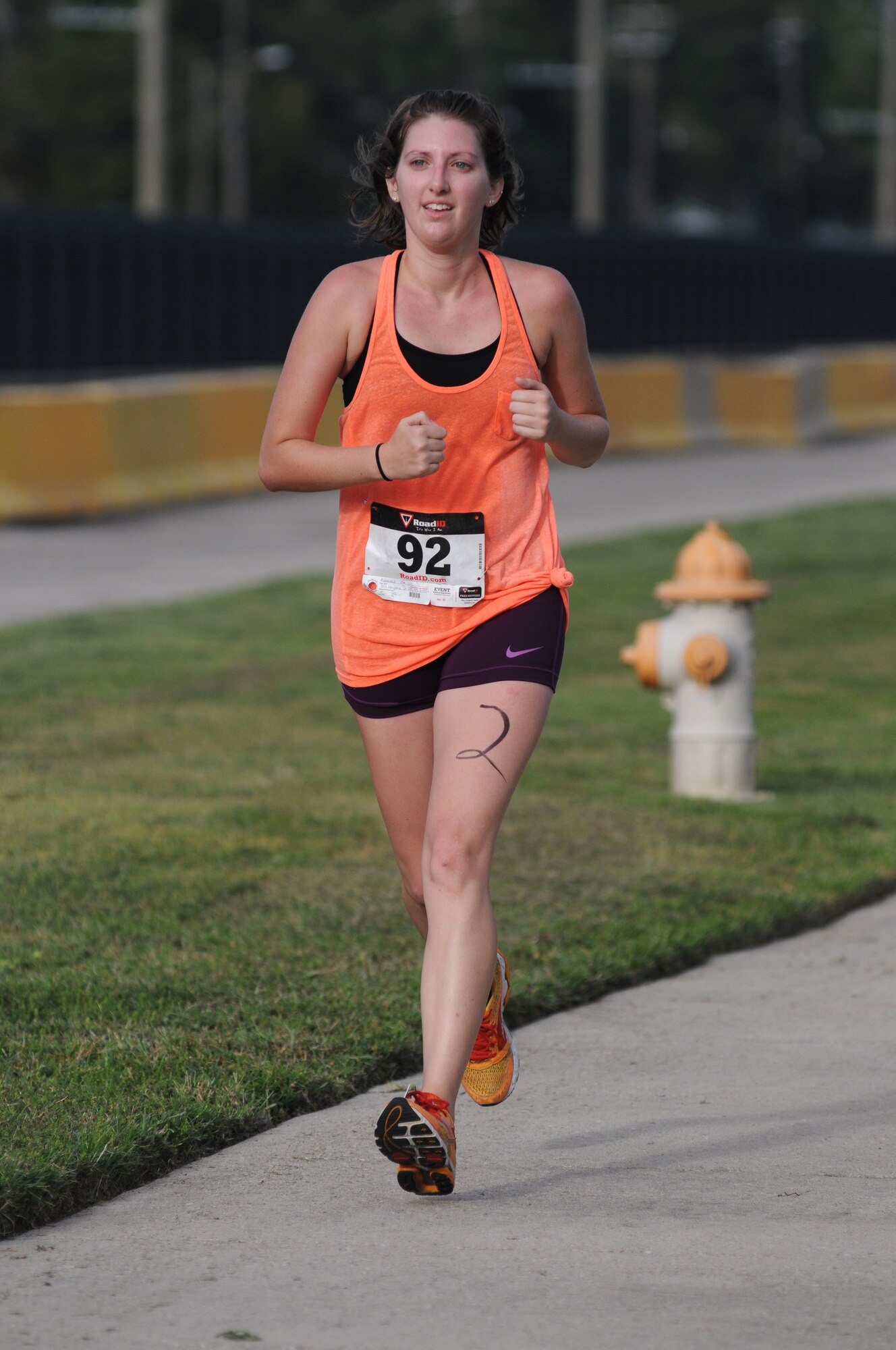 The daughter of Barry Newman, 81st Training Wing, run the last stretch of the 2-mile run, the final event of Keesler's mini-triathlon Sept. 26, 2014, at Keesler Air Force Base, Miss.  The event also included a 9-mile bike ride and a 200-yard swim.  (U.S. Air Force photo by Kemberly Groue)