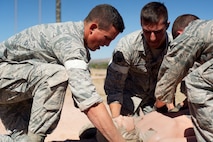The 91st Security Forces Group Global Strike Challenge team performs self-aid and buddy care during the mental and physical challenge on Camp Guernsey Wyo., Sept. 25, 2014. Nine teams competed in the security forces portion of the challenge. (U.S. Air Force photo/Senior Airman Brittany Y. Bateman)