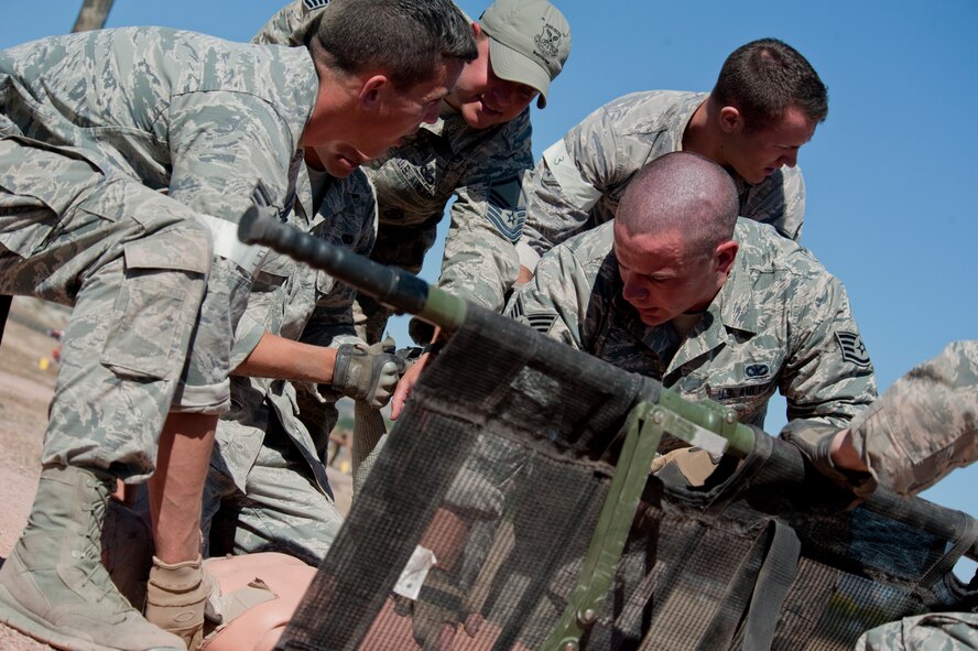 The 91st Security Forces Group Global Strike Challenge team performs self-aid and buddy care during the mental and physical challenge on Camp Guernsey Wyo., Sept. 25, 2014. Nine teams competed in the security forces portion of the challenge. (U.S. Air Force photo/Senior Airman Brittany Y. Bateman)