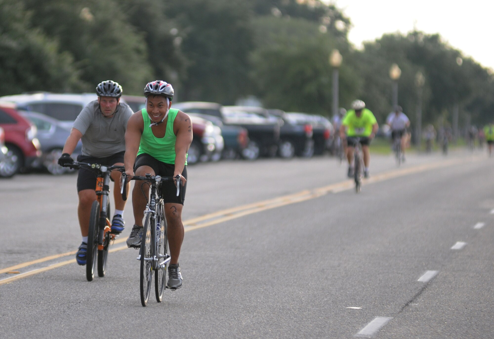 Capts. Paul McComas, 403rd Operations Support Squadron, and Josh Barroga, 333rd Training Squadron, cycles around the 9-mile bike course during Keesler's mini-triathlon Sept. 26, 2014, at Keesler Air Force Base, Miss.  The event also included a 2-mile run and a 200-yard swim.  (U.S. Air Force photo by Kemberly Groue)