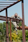 Staff Sgt. Ryan Fontaine, 91st Security Forces Group Global Strike Challenge team leader, moves from one obstacle to the next during the mental and physical challenge on Camp Guernsey Wyo., Sept. 25, 2014. Nine teams competed in the security forces portion of the challenge.  (U.S. Air Force photo/Senior Airman Brittany Y. Bateman)