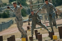 The 91st Security Forces Group Global Strike Challenge team competes in the mental and physical challenge on Camp Guernsey Wyo., Sept. 25, 2014. The security forces portion of the challenge was split into three different events; tactics, weapons firing, and the mental and physical challenge. (U.S. Air Force photo/Senior Airman Brittany Y. Bateman)
