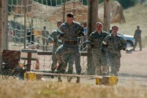 The 91st Security Forces Group Global Strike Challenge team competes in the mental and physical challenge on Camp Guernsey Wyo., Sept. 25, 2014. The security forces portion of the challenge was split into three different events; tactics, weapons firing, and the mental and physical challenge. (U.S. Air Force photo/Senior Airman Brittany Y. Bateman)
