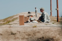 Members of the 91st Security Forces Group Global Strike Challenge team fire an M4 rifle during the weapons firing event at the 2014 GSC on Camp Guernsey, Wyo., Sept. 24, 2014. During the weapons firing event, the team fired the M9 pistol, M240 machine gun, M4 rifle and the M203 grenade launcher. (U.S. Air Force photo/Senior Airman Brittany Y. Bateman)