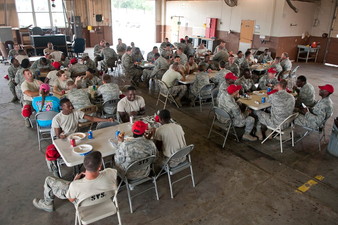 Members of the 307th RED HORSE and 307th Civil Engineer Squadrons enjoy a burger burn after a field training exercise at Barksdale Air Force Base, La., Sept. 11, 2014. More than 170 Airmen from both the 307th RHS and 307th Civil Engineer Squadron participated in a bivouac designed to complete yearly requirements in field and contingency skills training. (U.S. Air Force photo by Master Sgt. Jeff Walston/Released)
