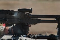 Senior Airman Cody Poole, 91st Security Forces Group Global Strike Challenge team member, fires an M240 machine gun during the weapons-firing event at the 2014 GSC on Camp Guernsey, Wyo., Sept. 24, 2014. During the weapons-firing event, the team also fired the M9 pistol, M4 rifle and the M203 grenade launcher.  (U.S. Air Force photo/Senior Airman Brittany Y. Bateman)