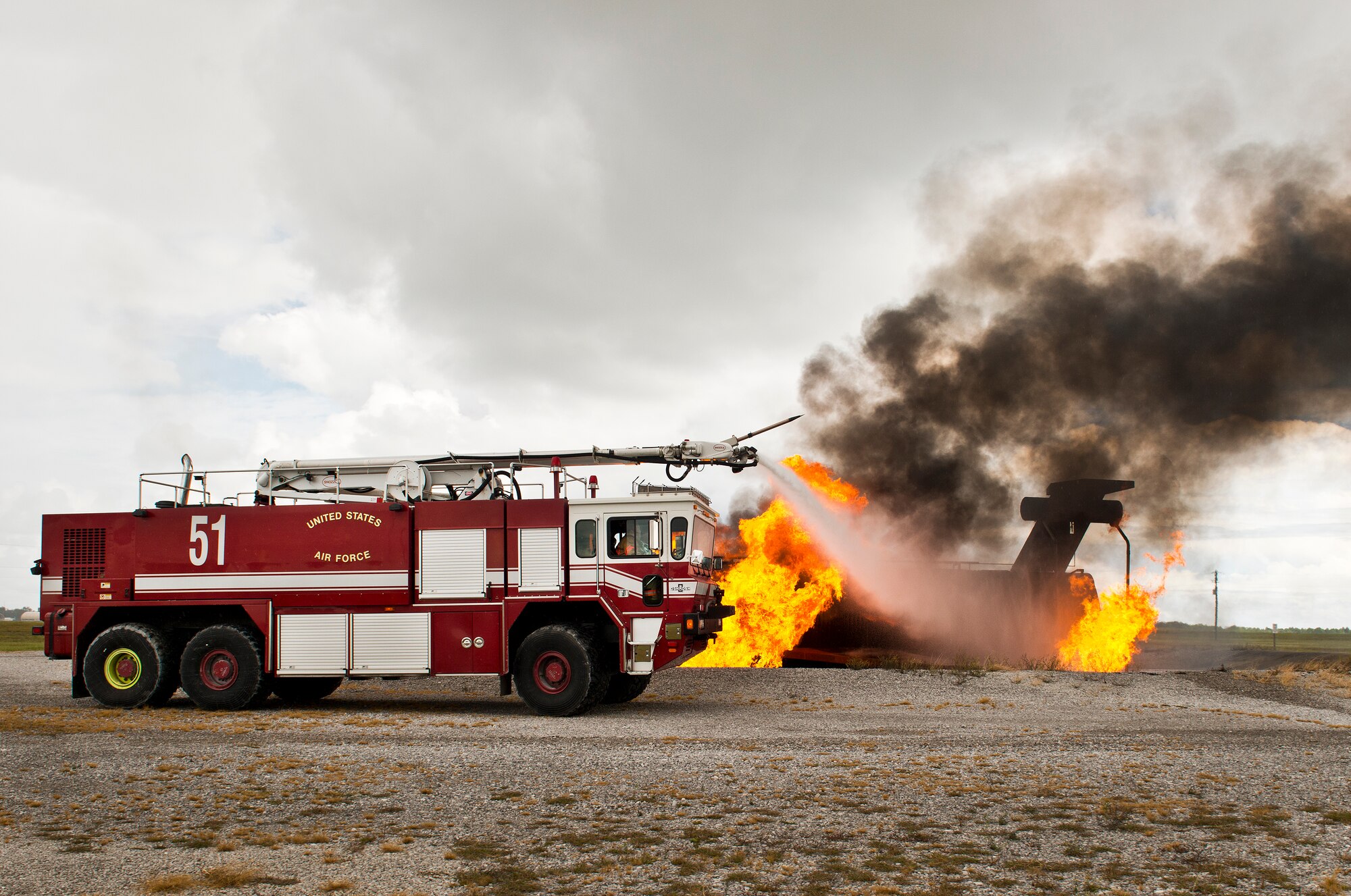Brig. Gen. David Harris, 96th Test Wing commander, attacks the aircraft fire from Fire Truck 51 Sept. 29 at Eglin Air Force Base, Fla.  Harris visited the 96th TW flightline fire department and participated in hands-on firefighter training including live fire, structural and confined spaces.  (U.S. Air Force photo/Samuel King Jr.)