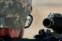 Capt. Kyle Yates, 91st Security Forces Group Global Strike Challenge team leader, looks through the sights of his M4 rifle during the weapons-firing event at the 2014 GSC on Camp Guernsey, Wyo., Sept. 24, 2014. Nine teams competed in the security forces portion of the challenge.  (U.S. Air Force photo/Senior Airman Brittany Y. Bateman)