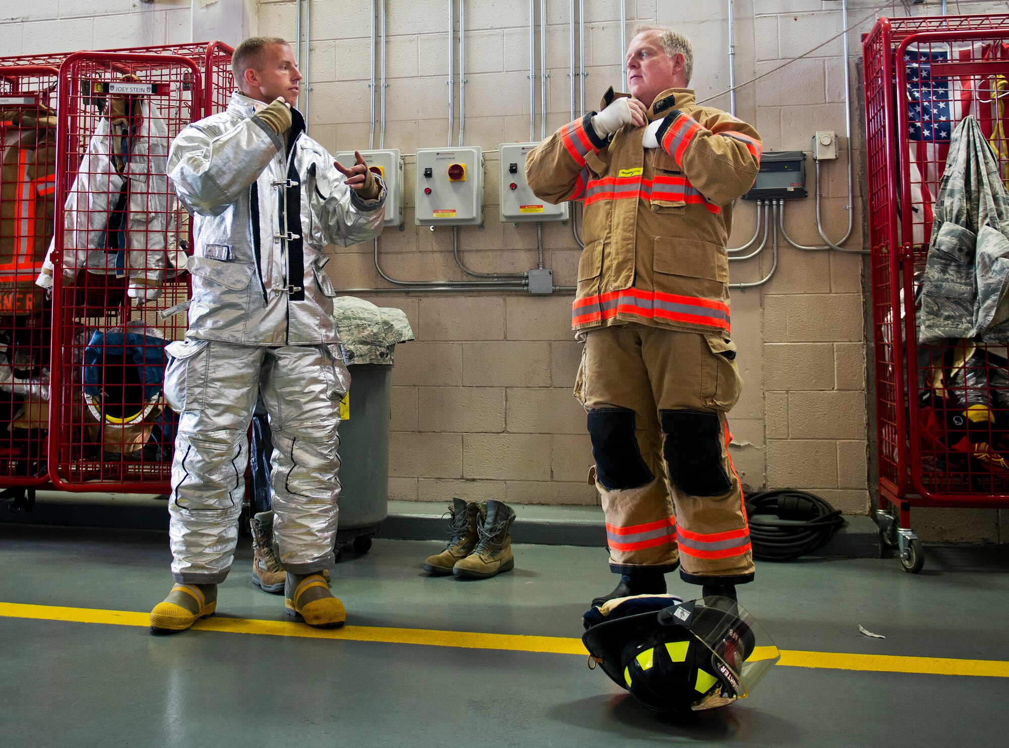 Eglin Air Force Base firefighter, Senior Airman Ryan Falk, and Brig. Gen. David Harris, 96th Test Wing commander, dress out in their firefighting gear Sept. 29 at the base fire station. Harris visited the 96th TW flightline fire department and participated in hands-on firefighter training including live fire, structural and confined spaces.  (U.S. Air Force photo/Samuel King Jr.)