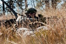 Capt. Kyle Yates, 91st Security Forces Group Global Strike Challenge team leader, provides cover during the tactics event of the competition on Camp Guernsey, Wyo., Sept. 24, 2014. The security forces portion of the challenge was split into three different events; tactics, weapons firing, and the mental and physical challenge. (U.S. Air Force photo/Senior Airman Brittany Y. Bateman)