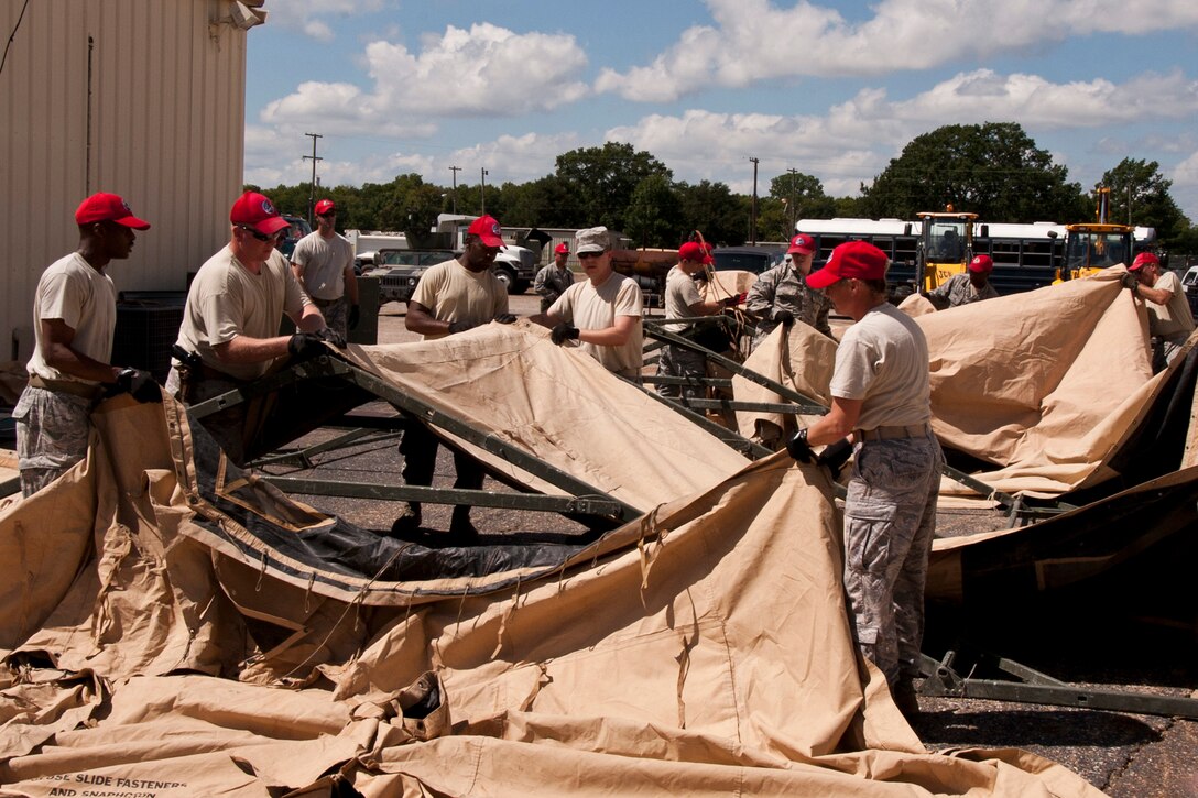 Members of the 307th RED HORSE and 307th Civil Engineer Squadron erect a TEMPER tent during a training exercise at Barksdale Air Force Base, La., Sept. 10, 2014. “Tent Erection” is part of yearly field training qualification needed to keep the Airmen up to date in their personal training certifications. (U.S. Air Force photo by Master Sgt. Jeff Walston/Released)