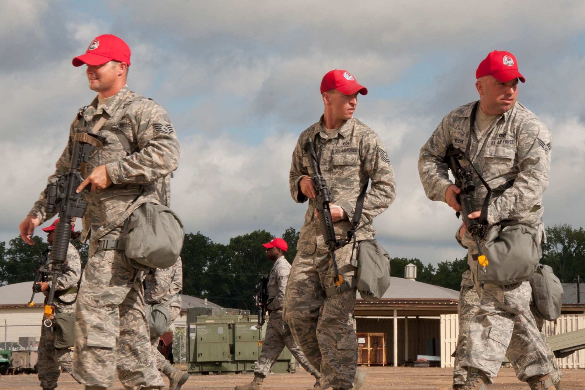 A group of Airmen assigned to the 307th RED HORSE Squadron cautiously cross a compound while clearing buildings during a training exercise at Barksdale Air Force Base, La., Sept. 10, 2014. More than 170 Airmen participated in a bivouac designed to complete yearly requirements in field and contingency skills training. (U.S. Air Force photo by Master Sgt. Jeff Walston/Released)
