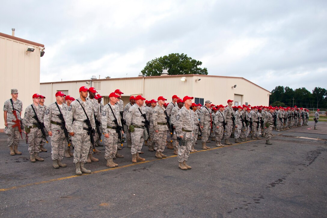 Members of the 307th RED HORSE and 307th Civil Engineer Squadrons stand in formation for a briefing before beginning a training exercise at Barksdale Air Force Base, La., Sept. 10, 2014. More than 170 Airmen participated in a bivouac designed to complete yearly requirements in field and contingency skills training. (U.S. Air Force photo by Master Sgt. Jeff Walston/Released)
