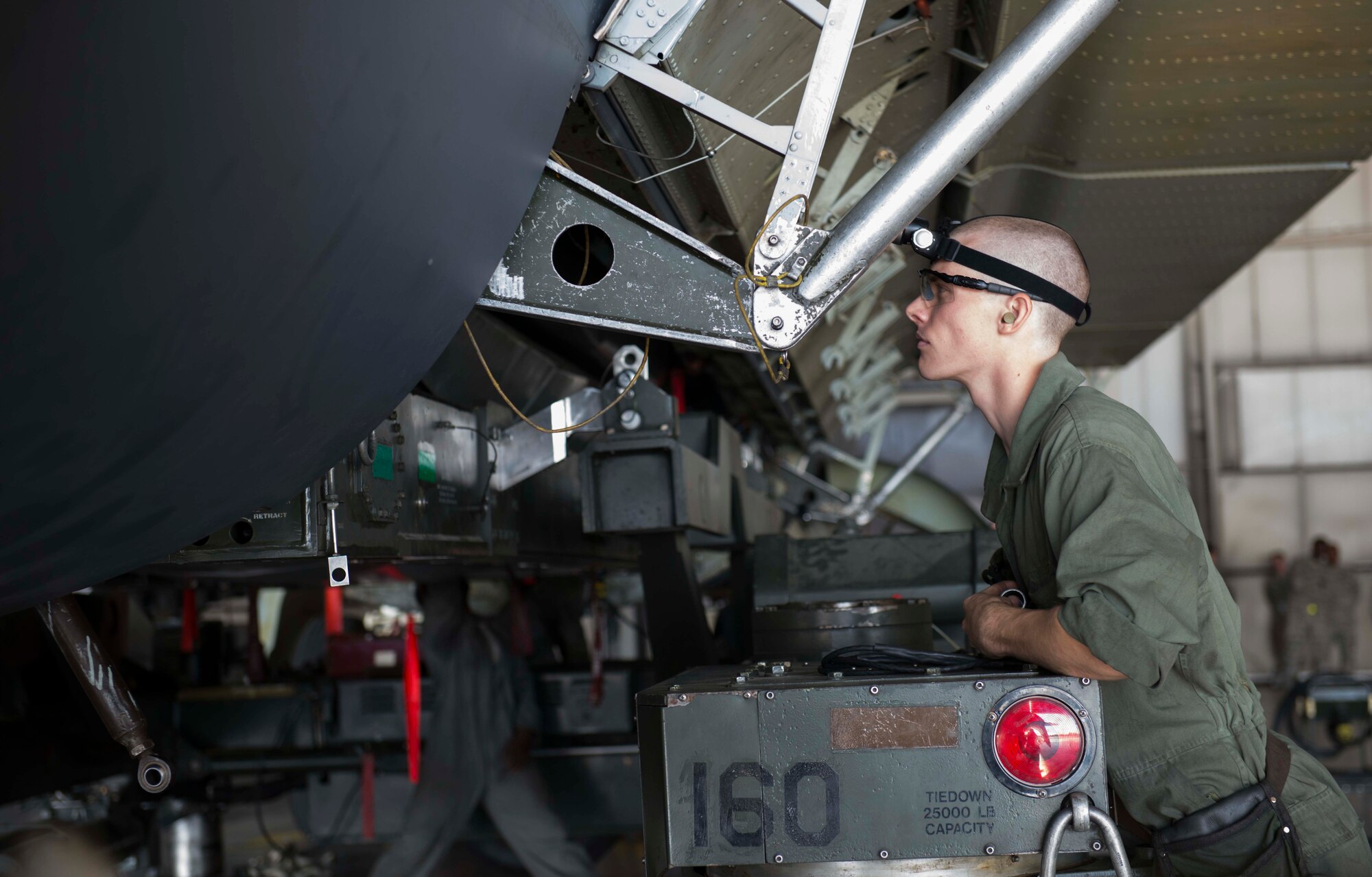 Airman 1st Class Michael Page, 5th Aircraft Maintenance Squadron weapons load crew member three man, watches the positioning of a weapon system during the Global Strike Challenge on Minot Air Force Base, Sept. 23, 2014. As part of a four-man team, Page worked with his teammates hoping to win the GSC title for Minot AFB. (U.S. Air Force photo/Airman 1st Class Lauren Pitts) 