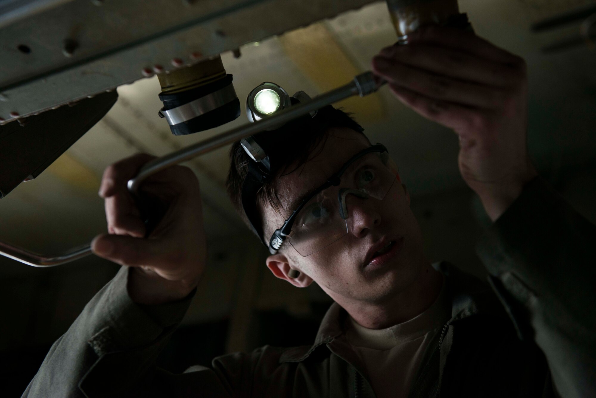 Senior Airman Andrew Grimes, 5th Aircraft Maintenance Squadron weapons load crew member two man, adjusts the tightness of a bolt during the Global Strike Challenge on Minot Air Force Base, Sept. 23, 2014. The four-man weapons load team competed in the challenge, working to achieve the best time for loading bombs onto a B-52H Stratofortress. (U.S. Air Force photo/Airman 1st Class Lauren Pitts) 