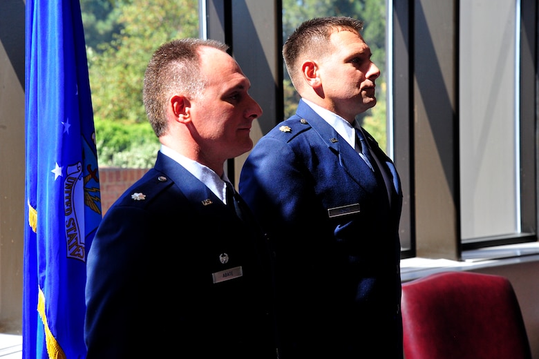 PETERSON AIR FORCE BASE, Colo. —Lt. Col. Christopher Abate (left), 21st Comptroller Squadron commander stands next to his younger brother, Maj. Stephan Abate, Operational Test and Evaluation Center Detachment 4 test director, as he presides over his retirement after 22-years of faithful and honorable service. (U.S. Air Force photo/Robb Lingley)