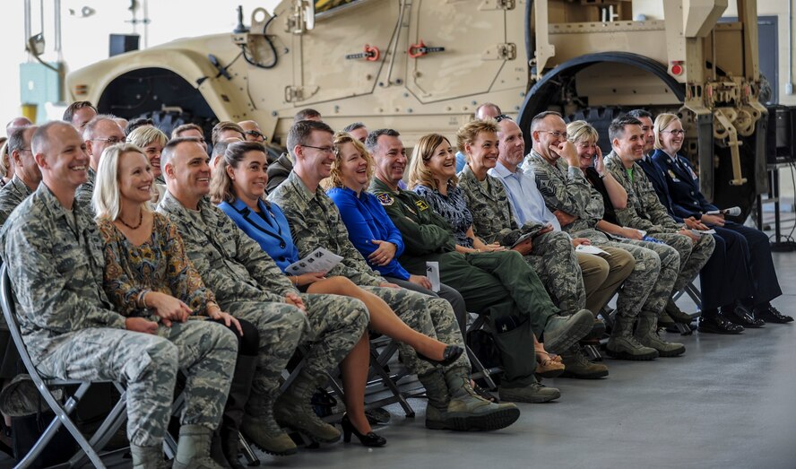 Team Moody leadership laughs at a joke during the retirement ceremony for U.S. Air Force Chief Master Sgt. Michael Goetz, 93d Air Ground Operations Wing Command Chief Sept 26, 2014, at Moody Air Force Base, Ga. Goetz served as the 93d AGOW Command Chief since May 2012.  (U.S. Air Force photo by Andrea Jenkins/Released)