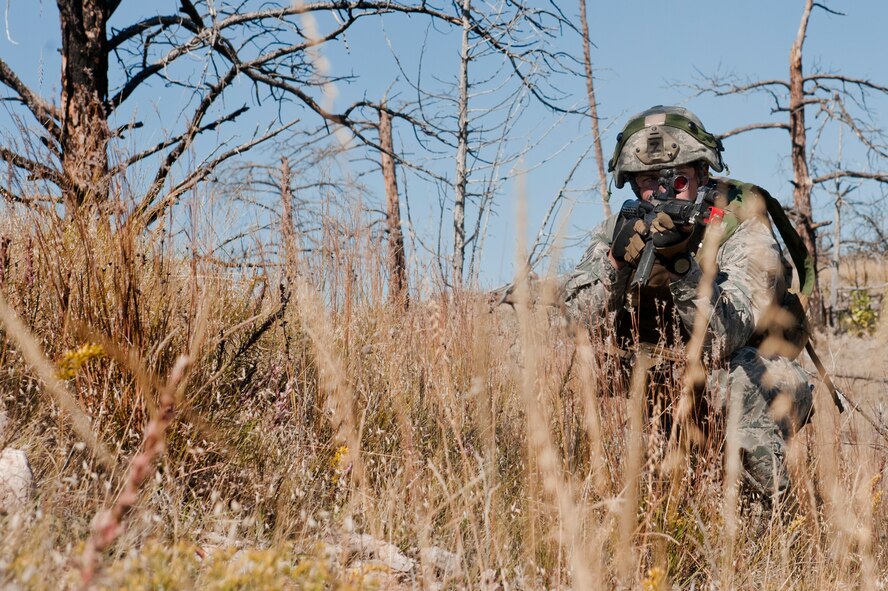 Staff Sgt. Ryan Fontaine, 91st Security Forces Group Global Strike Challenge team coach, provides cover during the tactics event on Camp Guernsey, Wyo., Sept. 24, 2014. Nine teams competed in the security forces portion of the challenge. (U.S. Air Force photo/Senior Airman Brittany Y. Bateman)