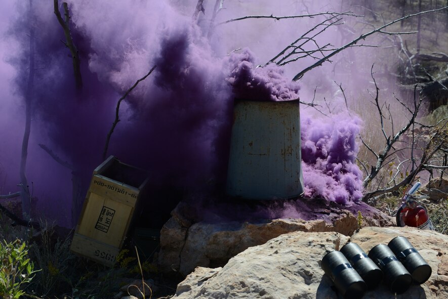 Smoke billows from a trash can during the tactics portion of the Global Strike Challenge at Camp Guernsey, Wyo., Sept. 24, 2014. During tactics, teams navigated their way through tall ridges, billowing smoke and sharp briers to a downed helicopter surrounded by enemy guards. (U.S. Air Force photo/Senior Airman Stephanie Morris)