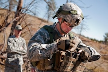 Staff Sgt. Ryan Fontaine, 91st Security Forces Group Global Strike Challenge team coach, prepares his gear during the tactics event of the 2014 GSC on Camp Guernsey, Wyo., Sept. 24, 2014. The security forces portion of the challenge was split into three different events; tactics, weapons firing, and the mental and physical challenge.  (U.S. Air Force photo/Senior Airman Brittany Y. Bateman)