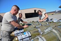 Airmen assigned to the 28th Aircraft Maintenance Squadron secure guided bomb units to a load trailer during the Global Strike Challenge at Ellsworth Air Force Base, S.D., Sept. 26, 2014. The event pits bomber, intercontinental ballistic missile and security forces teams from across the Air Force community against one another to improve combat capabilities and foster espirt de corps through competition and teamwork. (U.S. Air Force photo by Senior Airman Zachary Hada/Released)