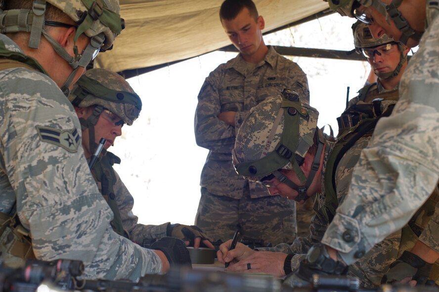 The 91st Security Forces Group Global Strike Challenge team strategizes for the tactics event on Camp Guernsey, Wyo., Sept. 24, 2014. Global Strike Challenge is the world's premier bomber, intercontinental ballistic missile and security forces competition with units participating from Air Force Global Strike Command, Air Combat Command, Air Force Material Command, Air Force Reserve Command and the Air National Guard.  (U.S. Air Force photo/Senior Airman Brittany Y. Bateman)