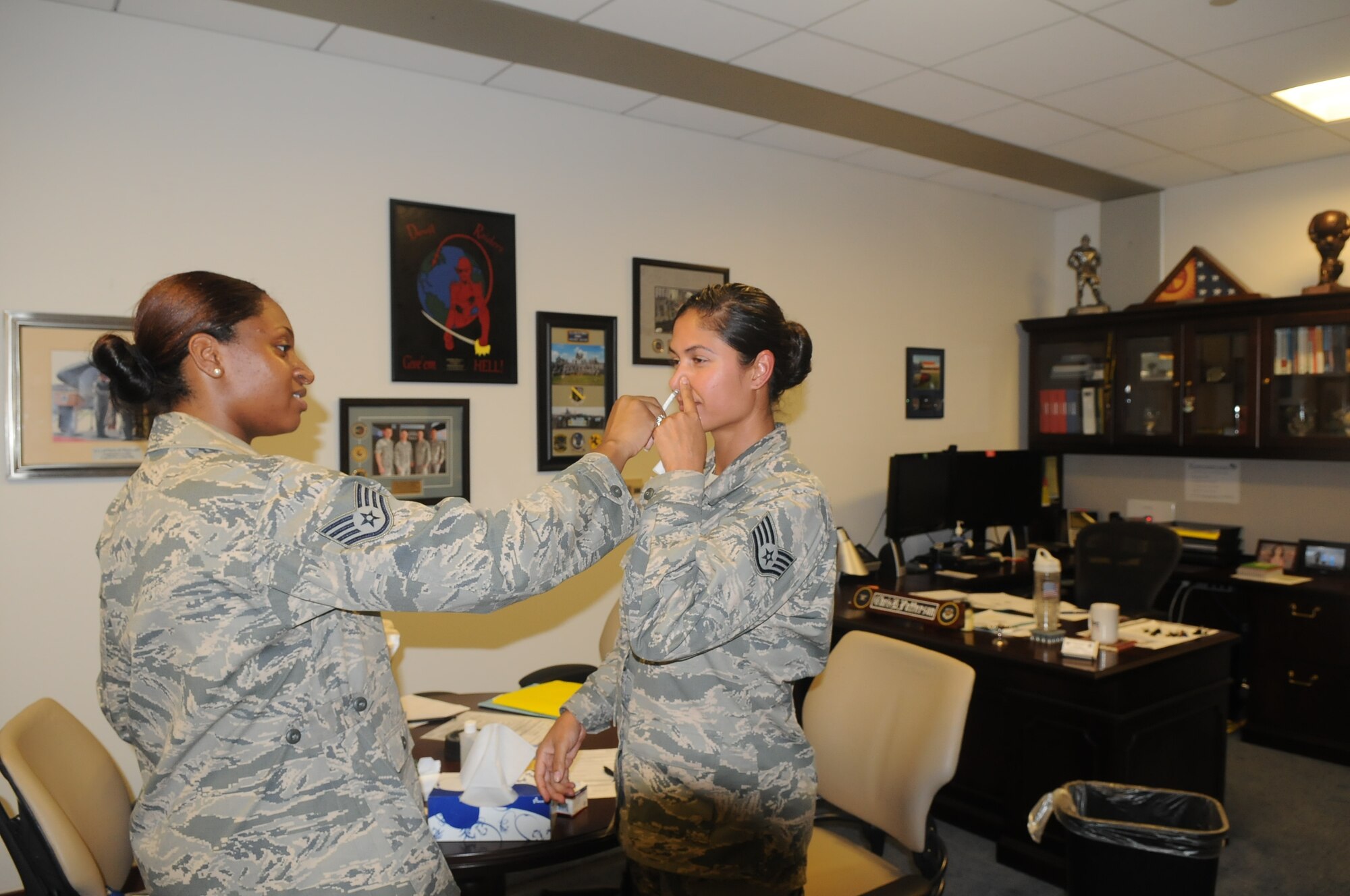 Staff Sgt. Jarimaris Garcia, command chief  executive assistant for the 79th Medical Wing received her flu mist on Sept. 25, 2014 by Staff Sgt. Sierra Johnson from 779th Medical Group Immunization Services Clinic.  The flu vaccine is mandatory for all military members and must be administered no later than Dec. 15.  (Air Force Photo)