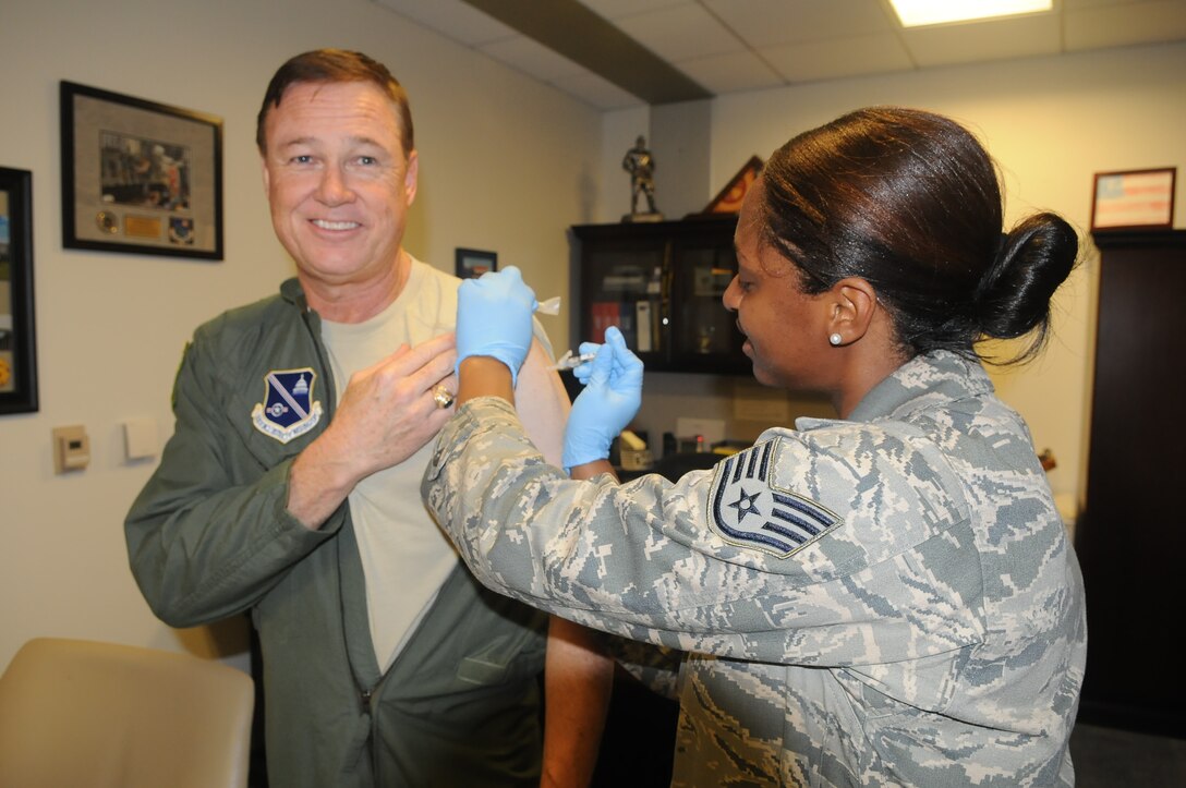 Maj. Gen.  Darryl Burke, commander for the Air Force District of Washington received his flu shot on Sept. 25, 2014 by Staff Sgt. Sierra Johnson from 779th Medical Group Immunization Services Clinic.  The flu vaccine is mandatory for all military members and must be administered no later than Dec. 15.  (Air Force Photo by Staff Sgt. Jarimaris Garcia)