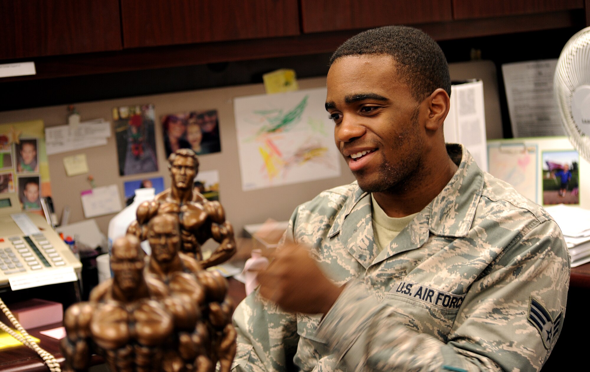 U.S. Air Force Senior Airman Maurice Cooper, a knowledge operations administrator of the 509th Bomb Wing, discusses his most recent bodybuilding competition Sept.23, 2014, at Whiteman Air Force Base, Mo. Cooper won second place in the men’s category and overall in the novice category, where he was also recognized for being a first-class competitor. (U.S. Air Force photo by Airman 1st Class Jovan Banks/Released)