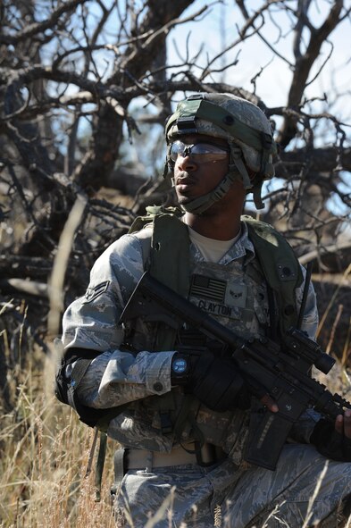 Airman 1st Class Michael Clayton, 5th Security Forces Squadron Global Strike Challenge team member, keeps watch during the tactics portion of the competition at Camp Guernsey, Wyo., Sept. 24, 2014. During the tactics portion of the competition, the team traversed rugged terrain, including steep hills and valleys, to reach a downed helicopter and liberate it from enemy forces. (U.S. Air Force photo/Senior Airman Stephanie Morris)