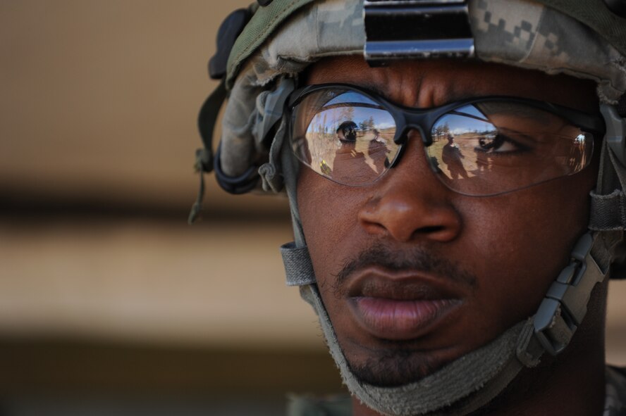 Airman 1st Class Michael Clayton, 5th Security Forces Squadron Global Strike Challenge team member, listens to instructions before the tactics portion of the competition at Camp Guernsey, Wyo., Sept. 24, 2014. During tactics, the team traversed rugged terrain, including steep hills and valleys, to reach a downed helicopter and liberate it from enemy forces. (U.S. Air Force photo/Senior Airman Stephanie Morris)