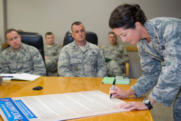 (right) Brig. Gen. Nina Armagno, 45th Space Wing commander, signs a National Disability Employment Awareness Month (NDEAM) and Triple Ribbon Month proclamation, Sept. 17, 2014, at Patrick Air Force Base, Fla. Held each October, NDEAM and Triple Ribbon Month are observed as part of a nationwide annual campaign to raise awareness. (U.S. Air Force photo/Matthew Jurgens)  