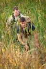 Team Minot Airmen make their way through a creek during the GORUCK Light Team Cohesion Challenge on Minot Air Force Base, N.D., Sept. 24, 2014. The five-hour ruck march included special operations-based obstacles and promoted teamwork. (U.S. Air Force photo/Airman 1st Class Apryl Hall)