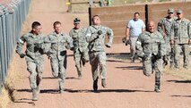 Airmen from the 28th Security Forces Squadron sprint toward the finish line on the obstacle course during the Global Strike Challenge competition at Camp Guernsey, Wyo., Sept. 25, 2014. The SFS team completed various physical and mental obstacles during the event, concluding with a half-mile sprint. (U.S. Air Force photo by Tech. Sgt. Jerry Fleshman/Released)