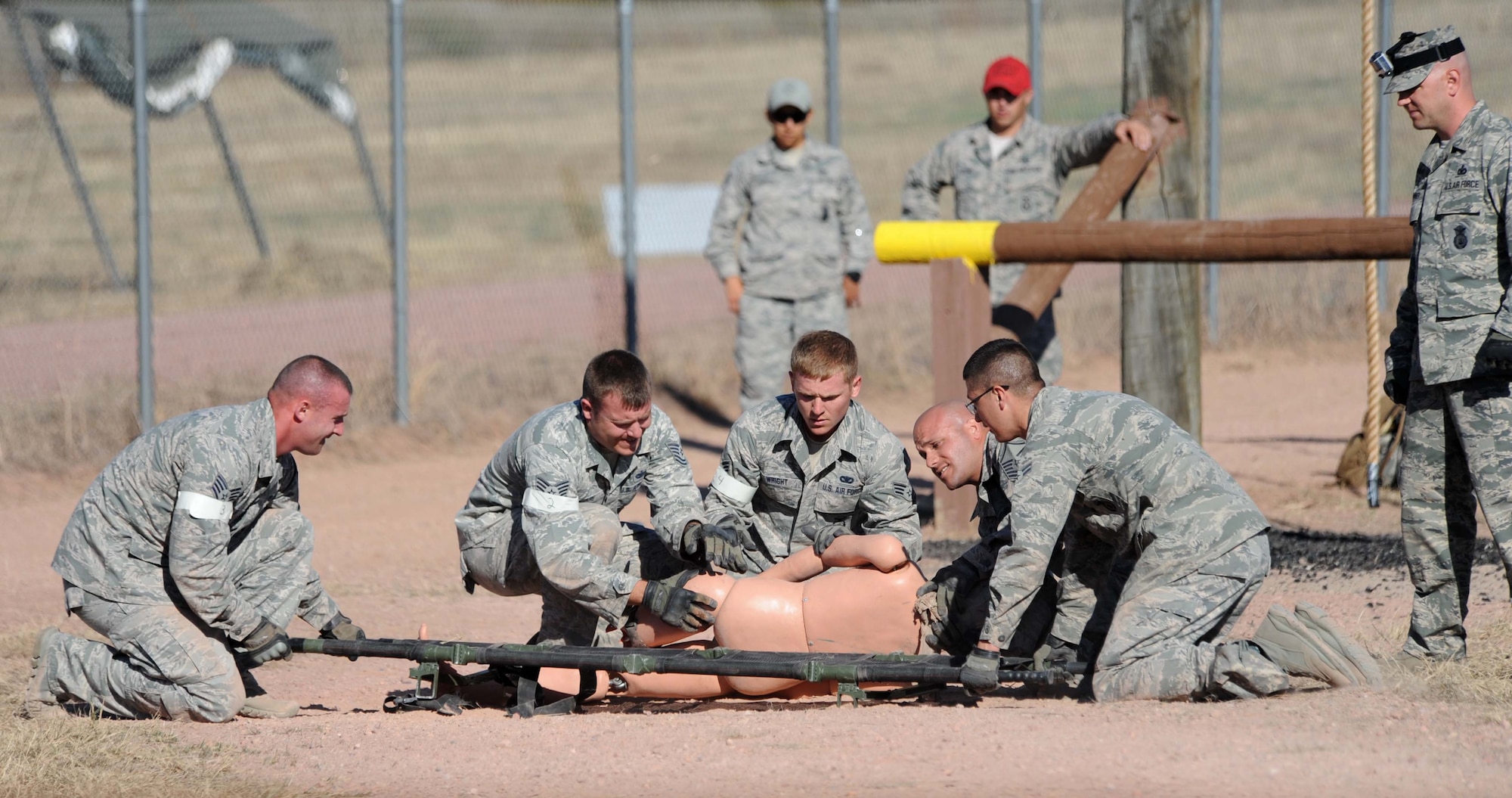 Members of the 28th Security Forces Squadron demonstrate self-aid buddy care treatment on the obstacle course during the Global Strike Challenge competition at Camp Guernsey, Wyo., Sept. 25, 2014. Global Strike Challenge is the world’s premier competition for bomber crews, Intercontinental Ballistic Missile crews and security forces and includes units from Air Combat Command, Air Force Global Strike Command, Air Force Reserve Command and the Air National Guard. (U.S. Air Force photo by Tech. Sgt. Jerry Fleshman/Released)