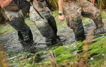 Team Minot Airmen walk through a creek during the GORUCK Light Team Cohesion Challenge on Minot Air Force Base, N.D., Sept. 24, 2014. The five-hour ruck march included special operations-based obstacles and promoted teamwork. (U.S. Air Force photo/Airman 1st Class Apryl Hall)