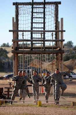 The 28th Security Forces team runs through an obstacle course during the Global Strike Challenge competition at Camp Guernsey, Wyo., Sept. 25, 2014. The 28th SFS was the only team representing Air Combat Command during the three day competition. (U.S. Air Force photo by Tech. Sgt. Jerry Fleshman/Released)