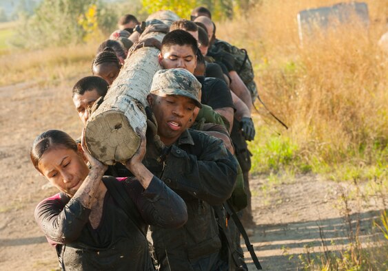 Team Minot Airmen carry a telephone pole during the GORUCK Light Team Cohesion Challenge on Minot Air Force Base, N.D., Sept. 24, 2014. The event, led by a GORUCK cadre, consisted of a five-hour ruck march that included several obstacles emulating special operations missions. (U.S. Air Force photo/Airman 1st Class Apryl Hall)