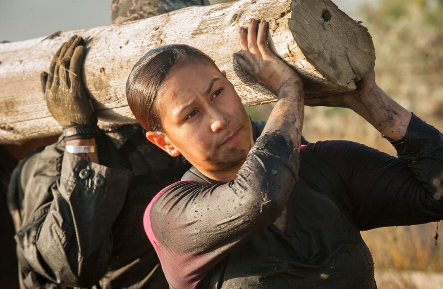 Senior Airman Rosa Gradilla-Viayra, 5th Force Support Squadron food service accountant, lifts a telephone pole during the GORUCK Light Team Cohesion Challenge on Minot Air Force Base, N.D., Sept. 24, 2014. The telephone pole carry was one of several team-building obstacles completed during the event. (U.S. Air Force photo/Airman 1st Class Apryl Hall)